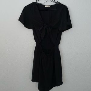 Size Medium Black Romper with Shorts. Stomach area is open/exposed.